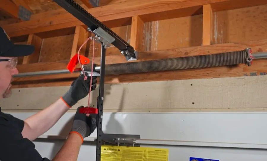Irving Garage Crew technician repairing a garage door spring in Irving, TX