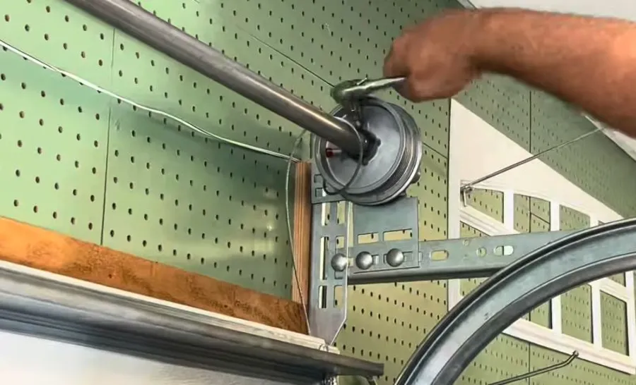 Loosening the drum set screws during garage door spring replacement