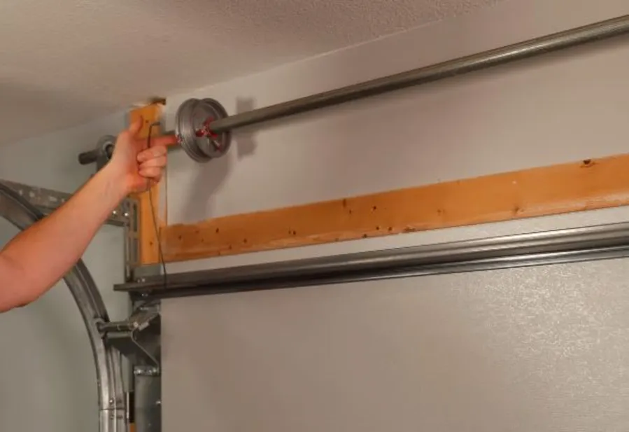 Reattaching and tensioning garage door cables after spring replacement