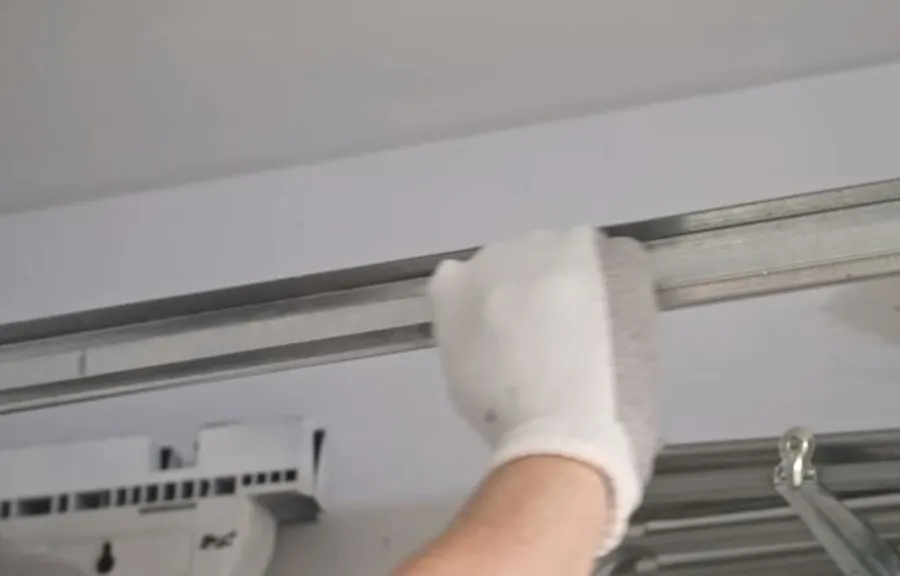 Cleaning a garage door roller track during an off-track door repair in South Irving, TX