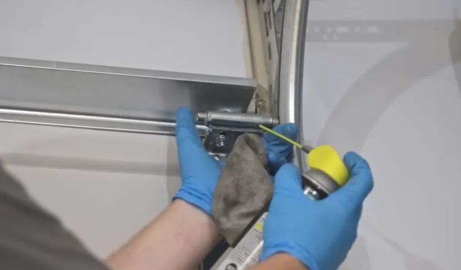 Irving Garage Crew technician repairing garage door roller pins in Irving, TX