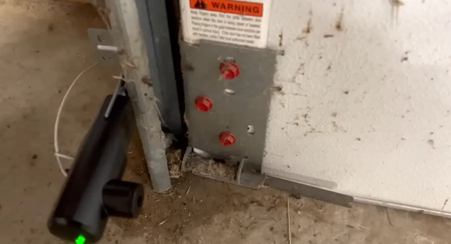 Garage door bottom roller bracket with the lift cable attached